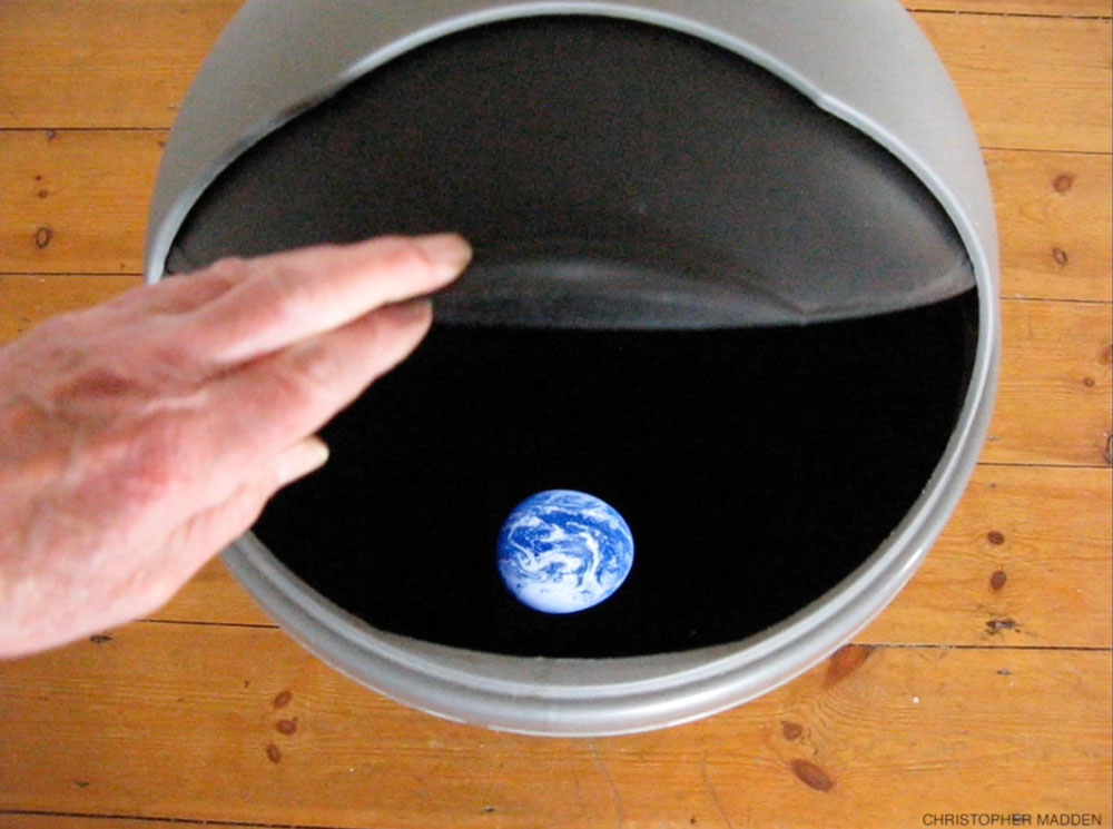 Environmental contemporary art installation - planet earth in a rubbish bin