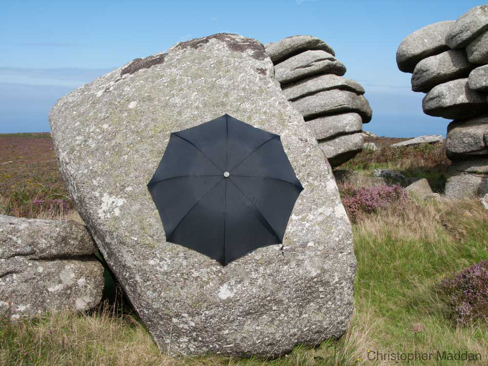 Contemporary art in the environment - umbrella on boulder